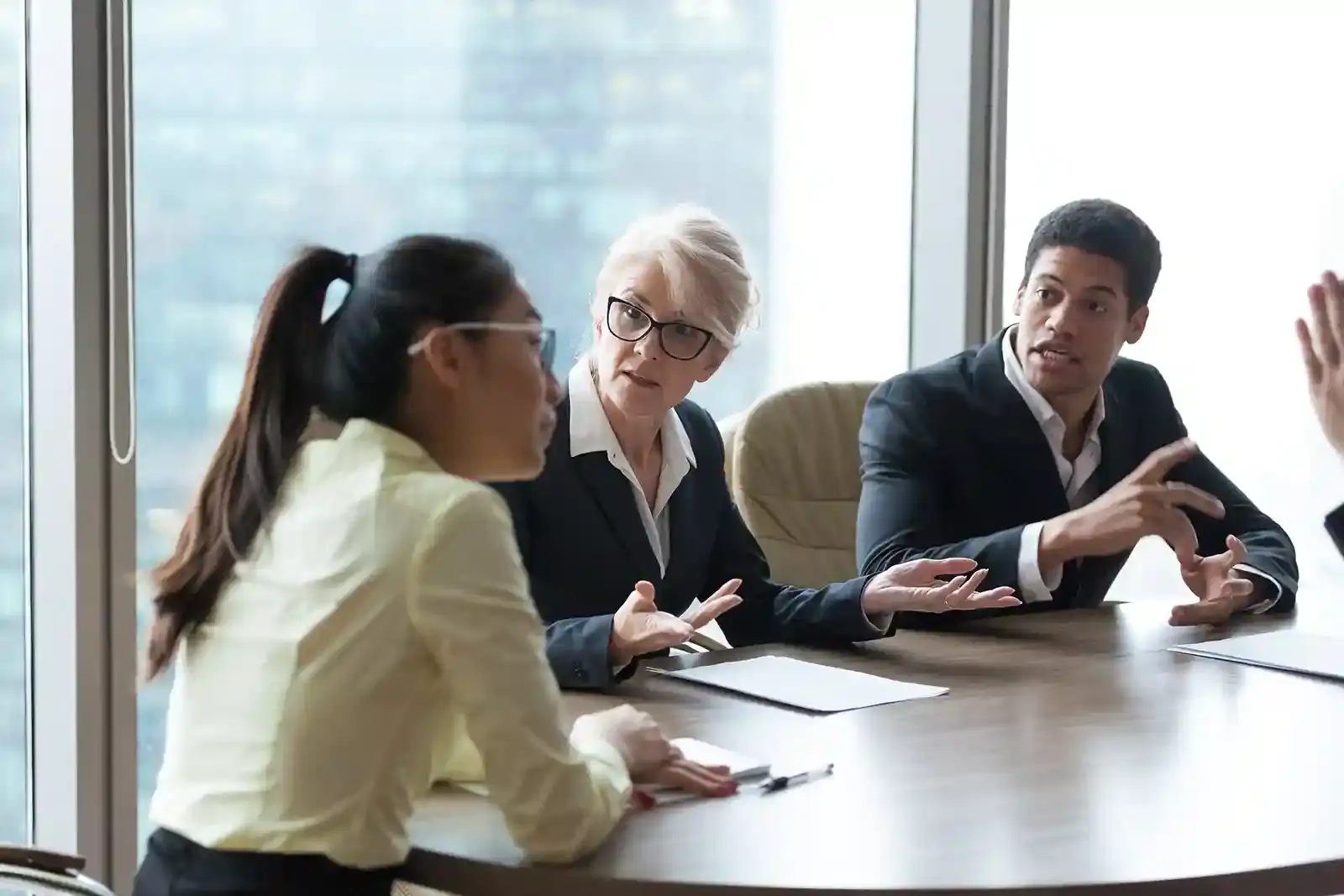 A financial planner meeting with clients around a conference table.