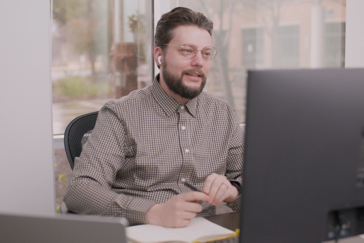 Fractional CTO sits at his desk on a video call