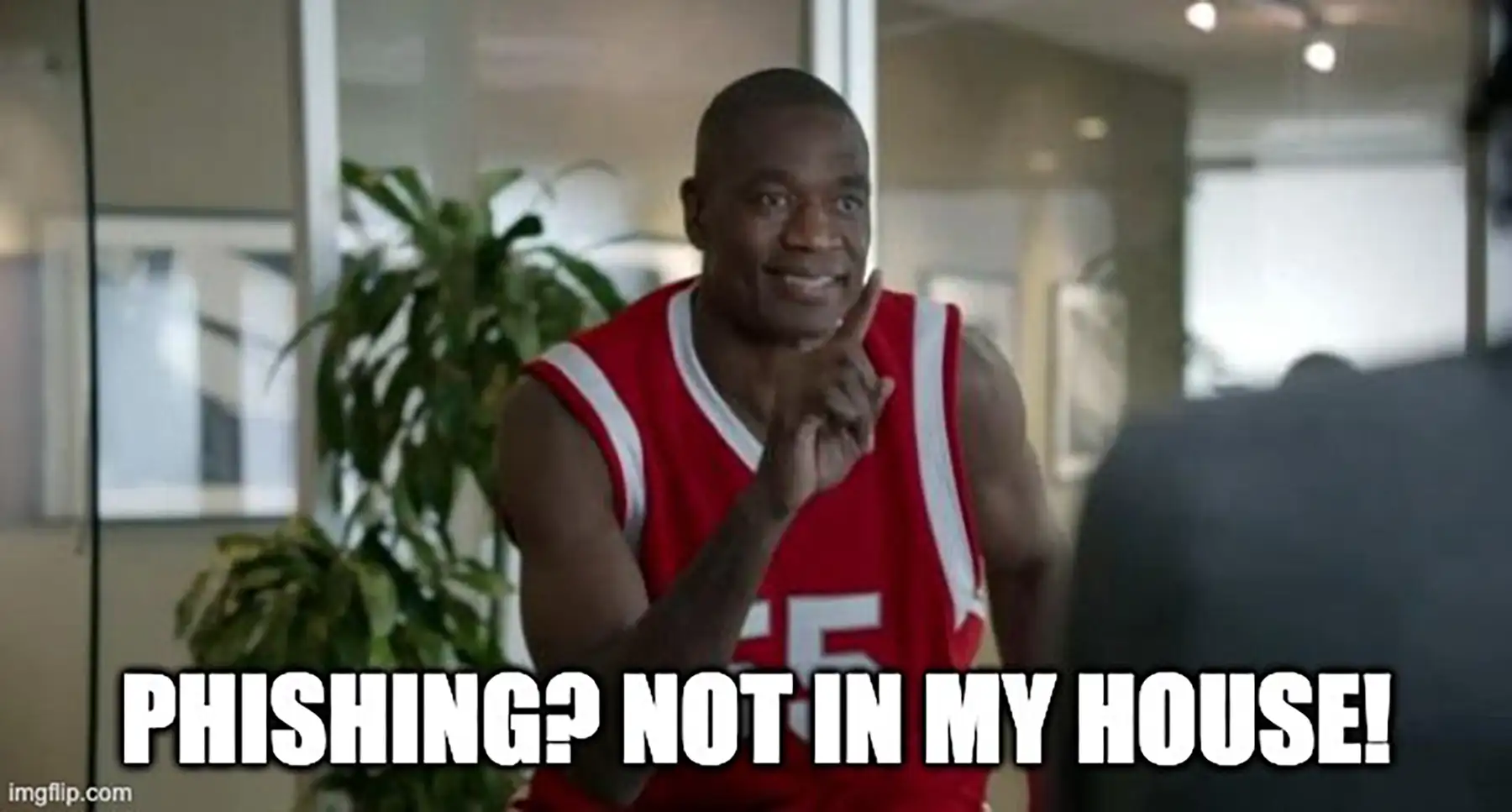 Phishing? Not in my house! a basketball player says, smiling, holding up a single finger.