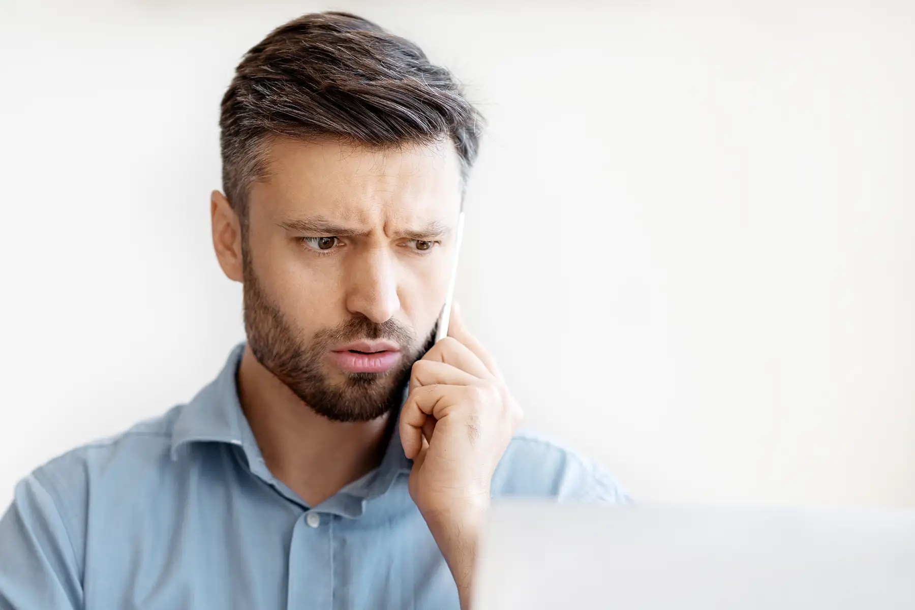 A man on the phone looks concerned.