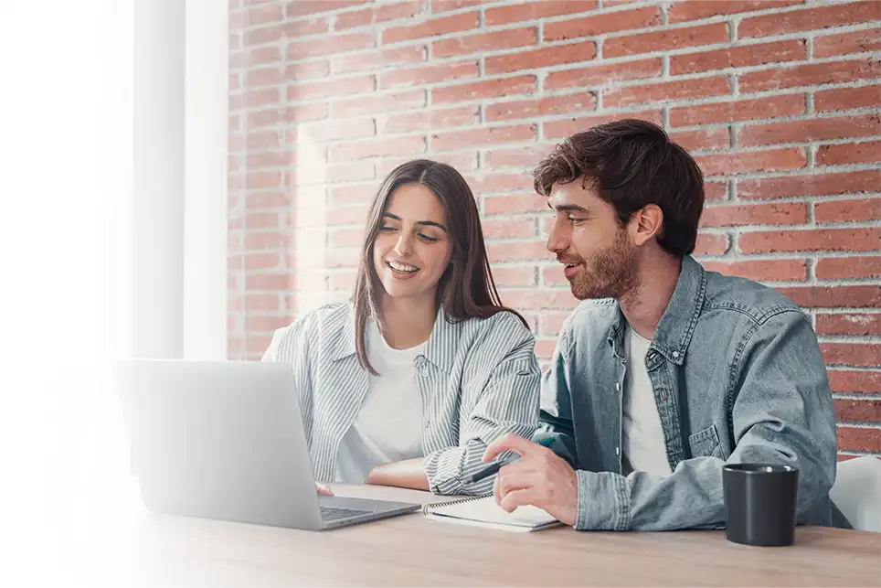 A couple happily plans their finances with a CFP remotely.