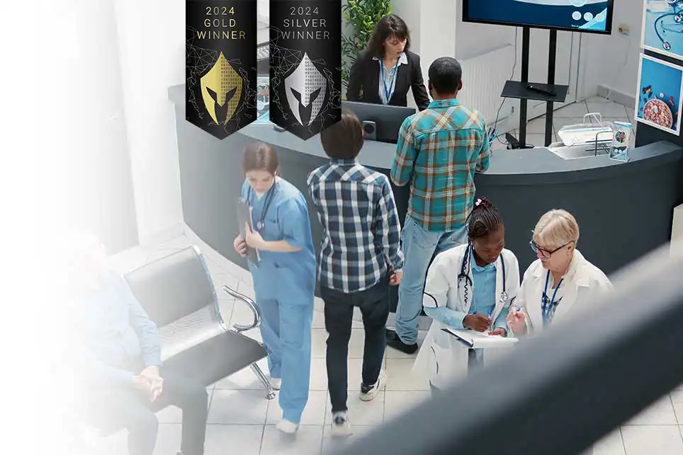 People in hospital waiting room checking in with 2 awards banners from VEGA overlaying the image