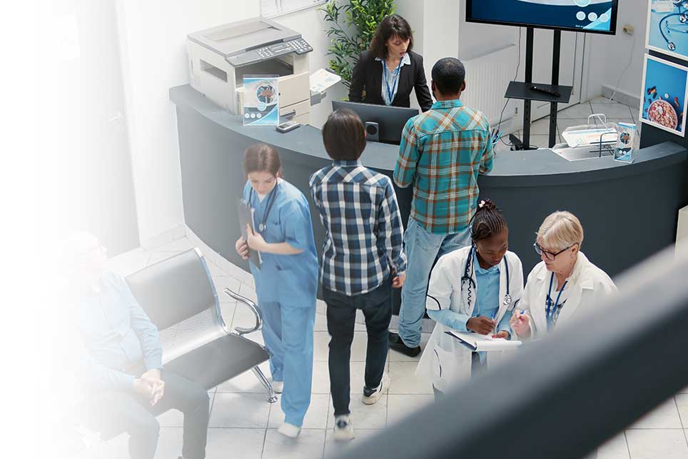 A hospital reception area with patients checking in.