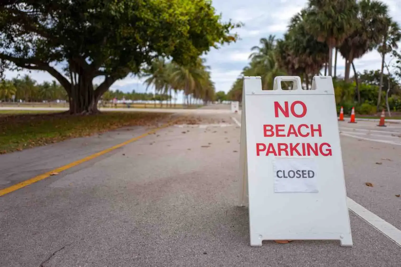 A sign that reads "No Beach Parking" is displayed in the road.