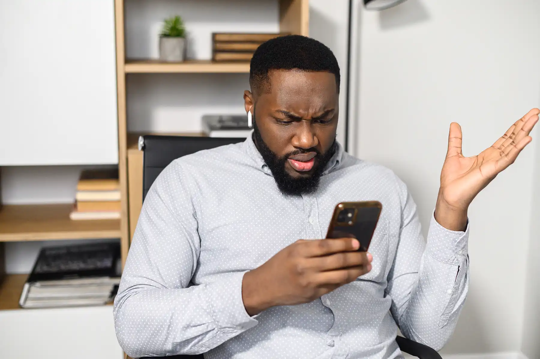 A man on a phone is visibly confused and frustrated using the software.