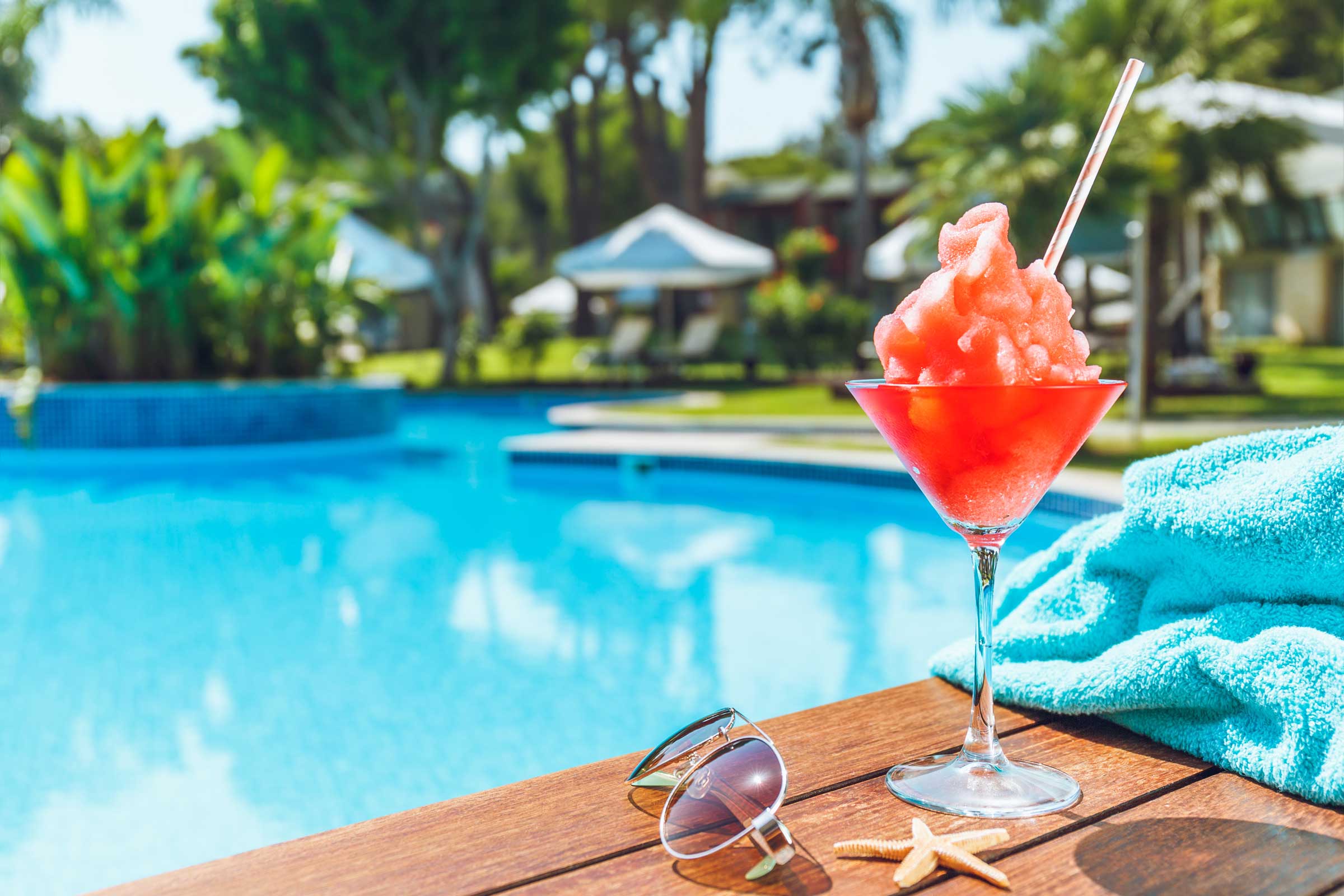 Yummy icee drink with a pool in the background.