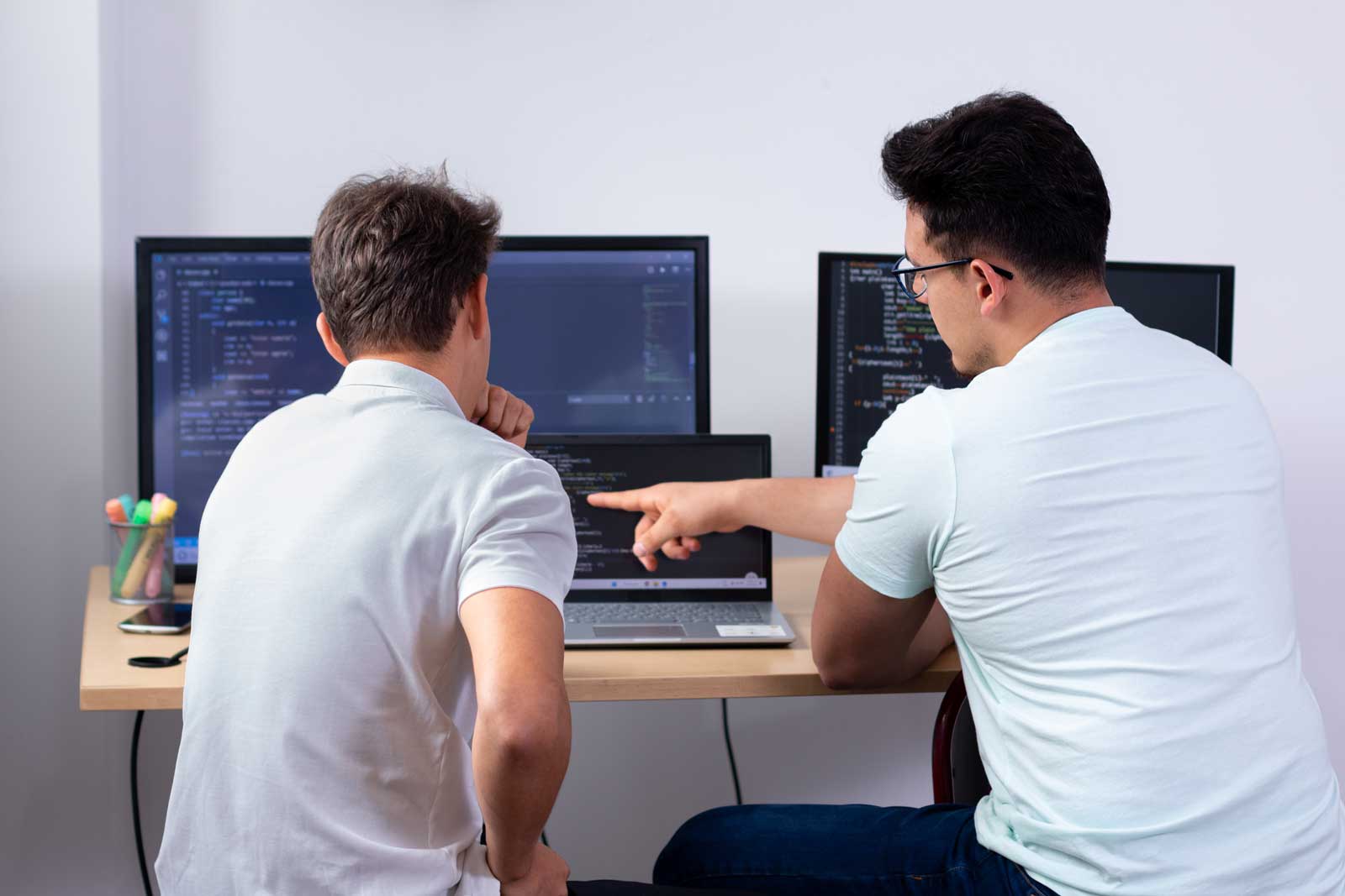 Two developers reviewing code side-by-side