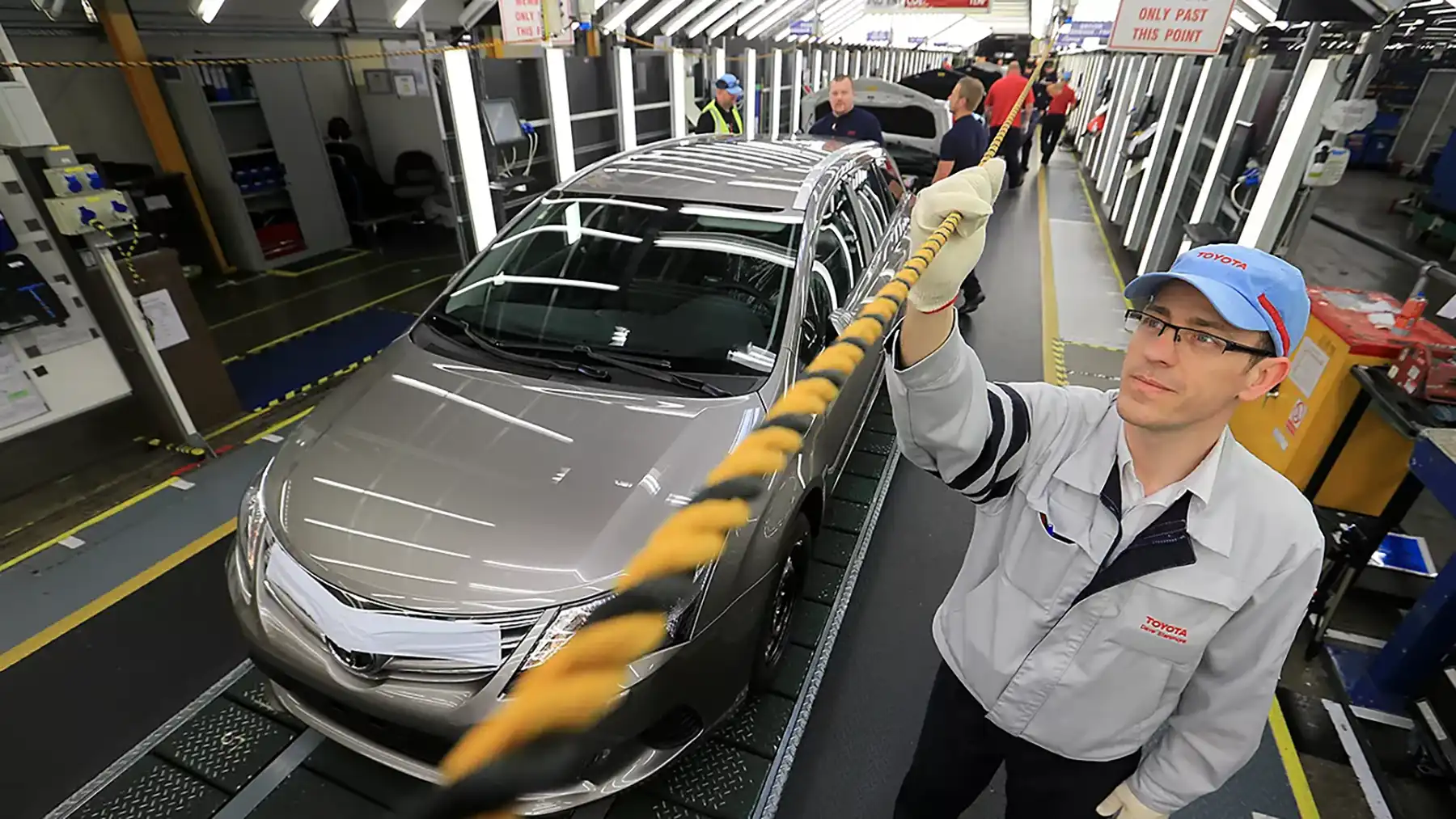 A Toyota employee pulls the andon cord to stop production and address a quality control issue.